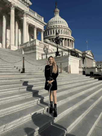 Keely wearing black on the white marble steps of the U.S. Capitol building in Washington, DC 