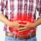 Man holding his stomach in pain